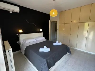 a bedroom with a bed with two towels on it at blue and green II in Chania Town