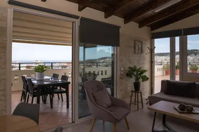 a living room with a table and a dining room at SunShine studio in Chania Town