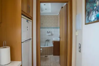 a bathroom with a tub and a toilet and a sink at SunShine studio in Chania Town