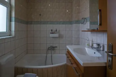 a bathroom with a tub and a sink at SunShine studio in Chania Town