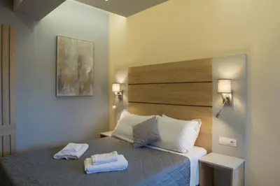a bedroom with a bed with two towels on it at SunShine studio in Chania Town