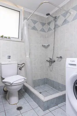 a bathroom with a shower and a toilet and a sink at Easy Living City Apartment in Chania Town