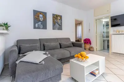 a living room with a couch and a table at Easy Living City Apartment in Chania Town