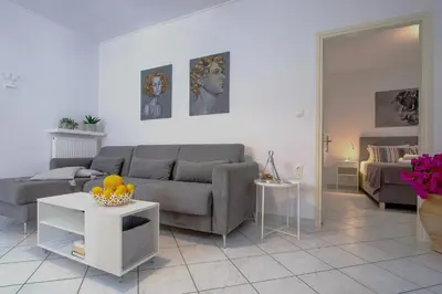 a living room with a couch and a table at Easy Living City Apartment in Chania Town