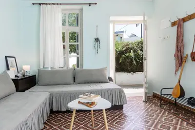 a living room with a couch and a table at Argiro's House - Chania Old Town in Chania Town