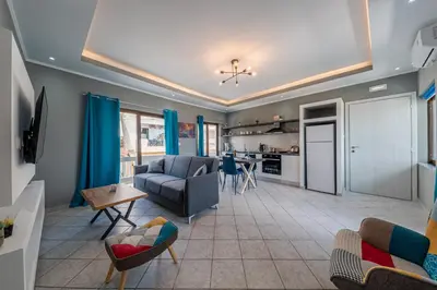 a living room with a couch and a kitchen at Luxury Sea View Apartment in Kolimvari in Kolymvari