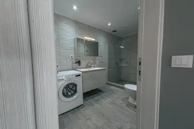 a bathroom with a washing machine and a toilet at Luxury Sea View Apartment in Kolimvari in Kolymvari