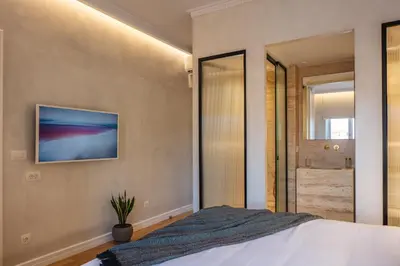 a bedroom with a bed and a sliding glass door at La Torre Residenza Imperiale in Chania Town