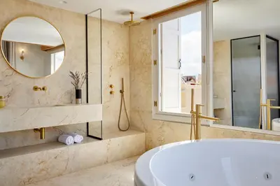 a bathroom with a tub and a mirror at La Torre Residenza Imperiale in Chania Town
