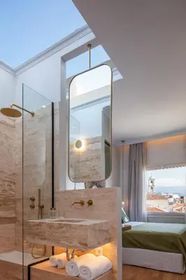 a bathroom with a sink and a mirror at La Torre Residenza Imperiale in Chania Town