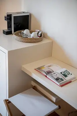 a counter with a table with a microwave and a magazine at Faedra Residence in Chania Town