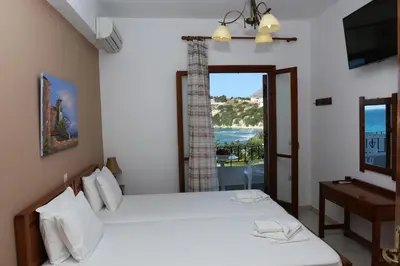 a bedroom with two beds and a window at kera apartments in Kalyves