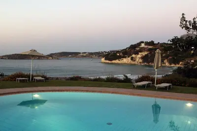 a swimming pool with a view of a body of water at kera apartments in Kalyves