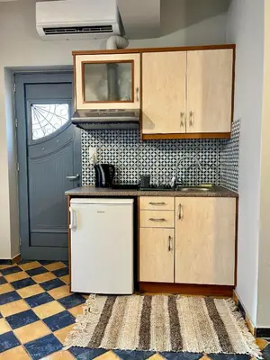 a kitchen with a sink and a refrigerator at Pink House 2 in Palaiochóra