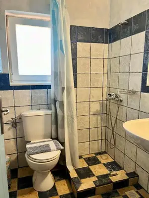 a bathroom with a toilet and a sink at Pink House 2 in Palaiochóra