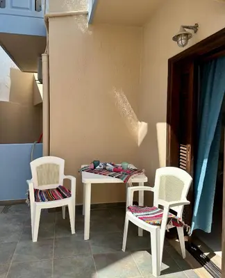 a table and two chairs and a table with a table and two chairs at BONATSA ROOMS in Palaiochóra
