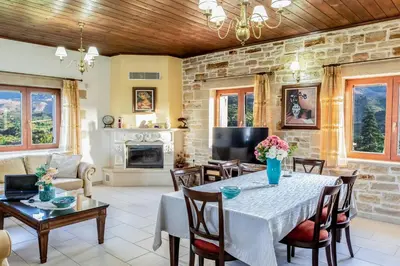 a living room with a table and a fireplace at Ktima Edem in Ramní