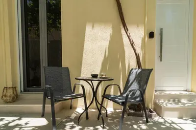 two chairs and a table on a porch at Gemma Apartments in Palaiochóra