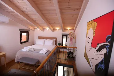 a bedroom with a bed on a balcony at Kabanas 3 cosy suite in Chania Town