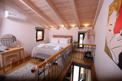 a bedroom with a bed and a balcony at Kabanas 3 cosy suite in Chania Town