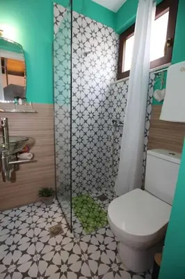 a bathroom with a toilet and a shower at Kabanas 3 cosy suite in Chania Town