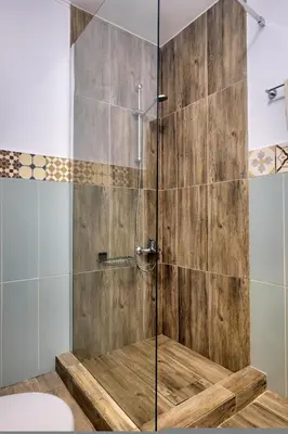 a bathroom with a shower with a glass door at Apartments Panethimos in Panéthimos