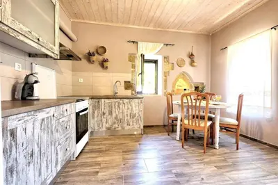 a kitchen with a table and a dining room at Apartments Panethimos in Panéthimos
