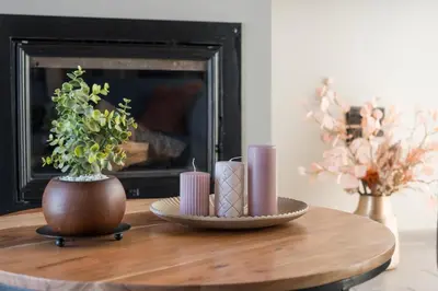 a coffee table with a candle and a vase with a plant at Natura Hill Villa III Sunset View in Kounoupidhianá