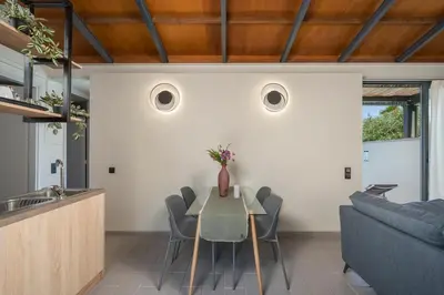 a kitchen and dining room with a table and chairs at Natura Hill Villa III Sunset View in Kounoupidhianá