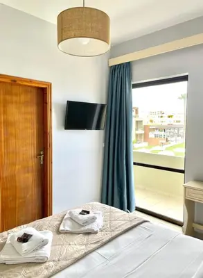 a bedroom with a bed with towels on it at wave rooms sea view in Maleme