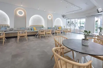 a room with tables and chairs and a couch at Epavli Grace Hotel in Chania Town