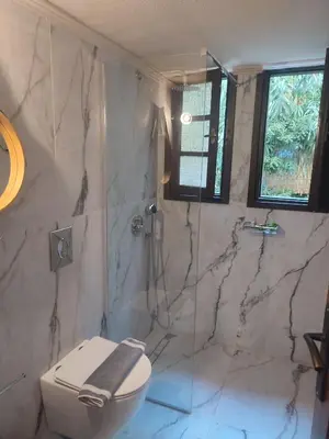 a bathroom with a toilet and a glass shower at Evangelos Apartments in Plataniás