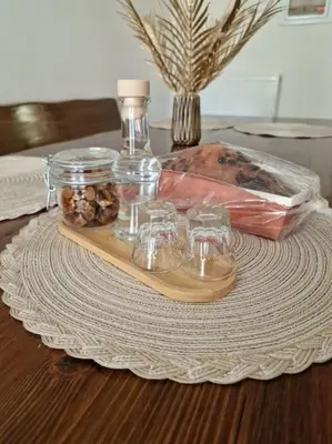 a tray with glasses and a bottle on a table at Korais apartment, Chania Crete in Kounoupidhianá