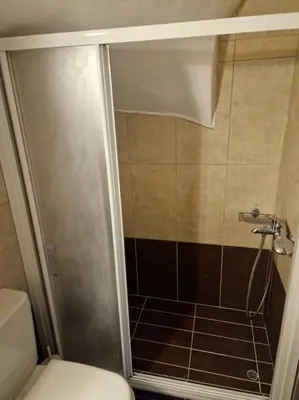 a bathroom with a shower with a toilet and a shower at Korais apartment, Chania Crete in Kounoupidhianá
