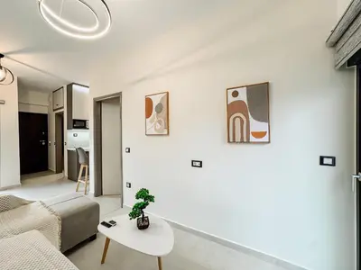a living room with a couch and a table at Comfy Corner Luxury Apartment in Chania Town