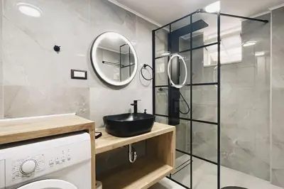 a bathroom with a sink and a mirror at Comfy Corner Luxury Apartment in Chania Town