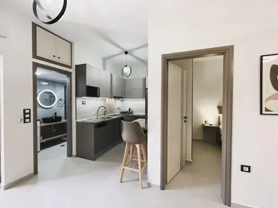 a kitchen with a door open to a kitchen with a stool at Comfy Corner Luxury Apartment in Chania Town