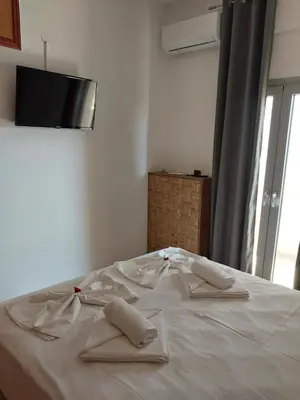 a white bed with two pillows on top of it at Passatempo Casa - 3 bedroom apartment close to the swimming pool in Gerani Chanion