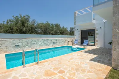 a swimming pool in the backyard of a villa at Megalith Villas in Agia Marina Nea Kydonias