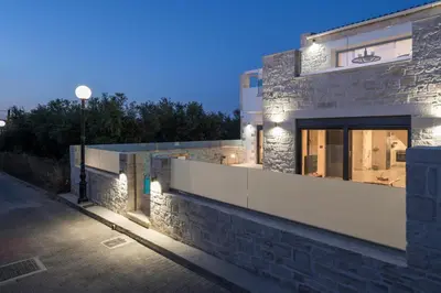 a building with lights on the side of a street at Megalith Villas in Agia Marina Nea Kydonias