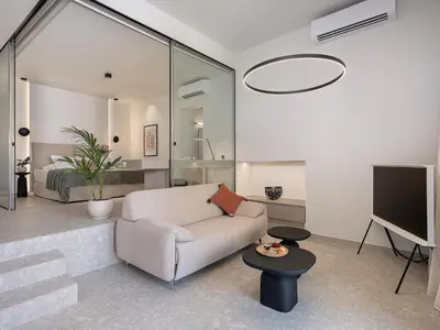 a living room with a couch and a tv at Ares Luxurious Residence in Kolymvari