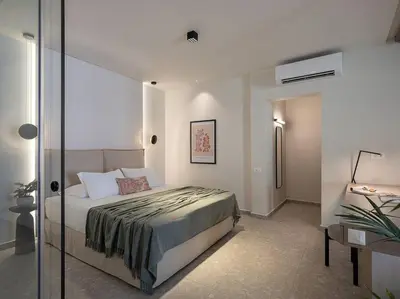 a bedroom with a bed and a glass wall at Ares Luxurious Residence in Kolymvari