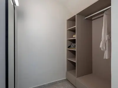 a walk in closet with white walls and a door at Ares Luxurious Residence in Kolymvari