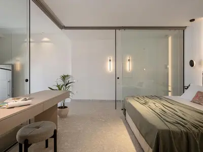 a bedroom with a bed and a desk and a shower at Ares Luxurious Residence in Kolymvari