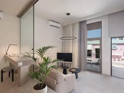 a living room with a couch and a desk at Ares Luxurious Residence in Kolymvari