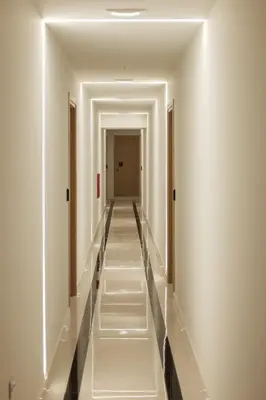 a long corridor with white walls and white ceilings at Sky-High Central Penthouse w. Stunning Views - 01 in Chania Town
