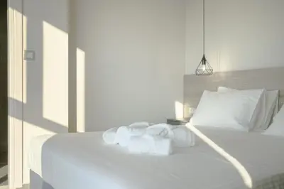 a bedroom with a white bed with towels on it at Sky-High Central Penthouse w. Stunning Views - 01 in Chania Town