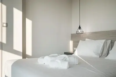 a bedroom with a white bed with towels on it at Sky-High Central Penthouse w. Stunning Views - 01 in Chania Town