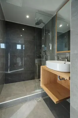 a bathroom with a sink and a glass shower at Sky-High Central Penthouse w. Stunning Views - 01 in Chania Town