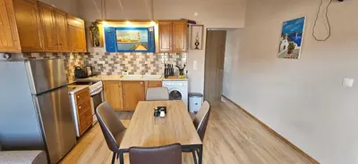 a kitchen with a table and chairs in a kitchen at 4Seasons in Chania Town